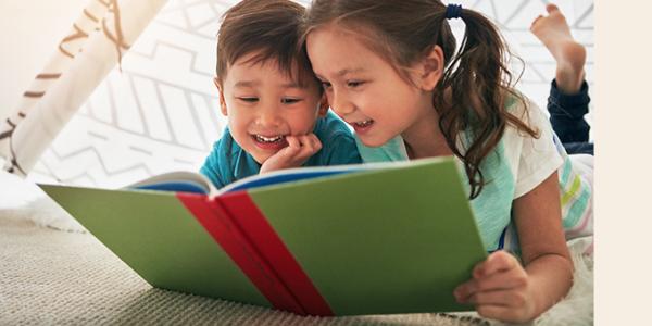 Two children reading a book