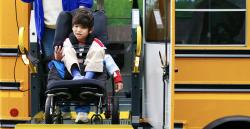 a child in a wheelchair exiting a bus