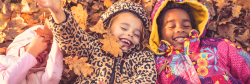Three girls playing in leaves